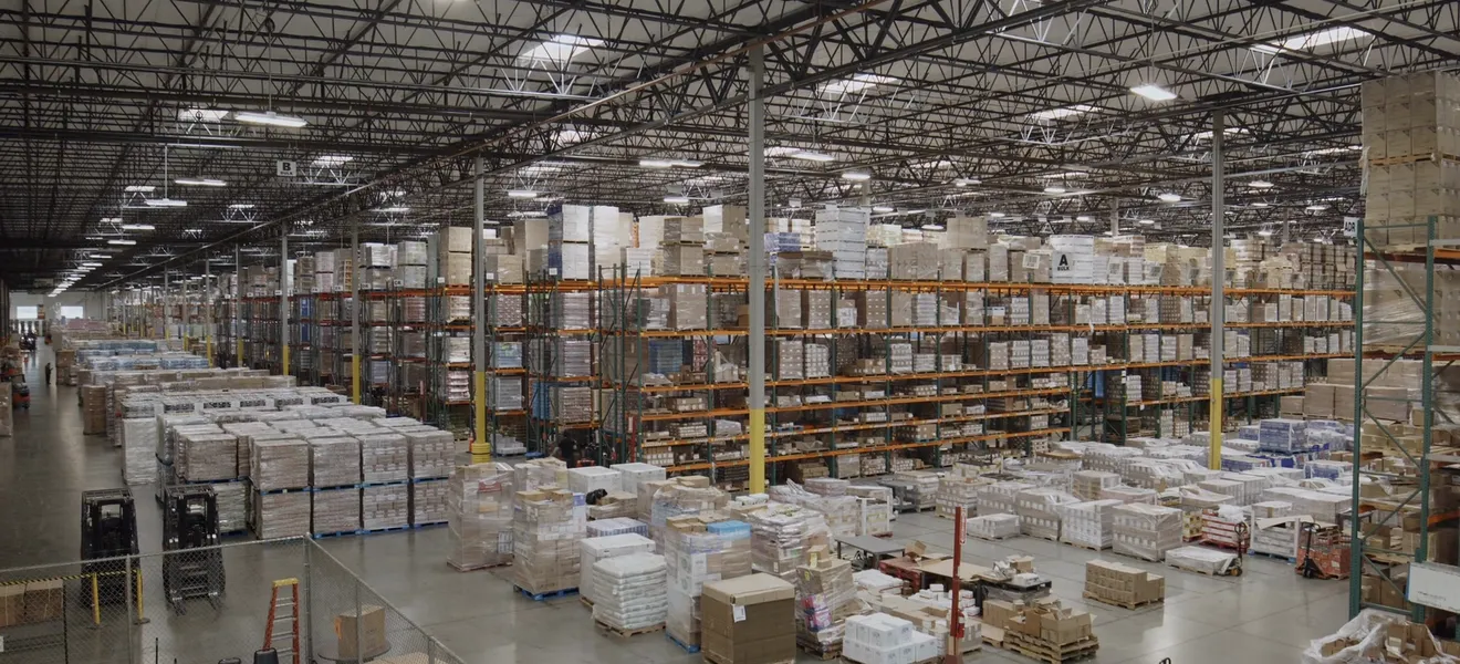 A large warehouse floor with racking and staged pallets