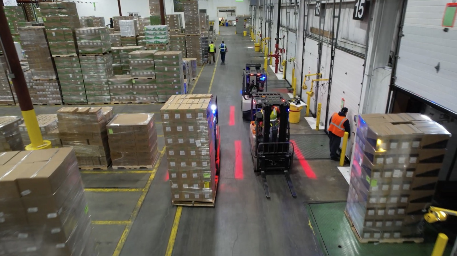 Forklifts and operators working a warehouse dock
