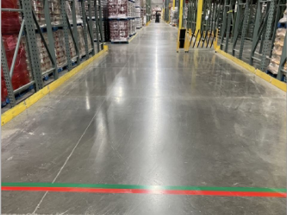 A restricted zone marked on the floor at the end of an aisle